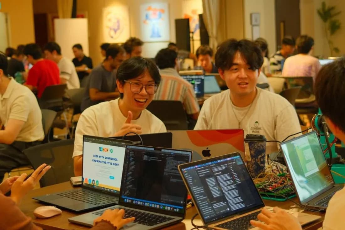 People coding around a table at the GPT-6 Astra hackathon.