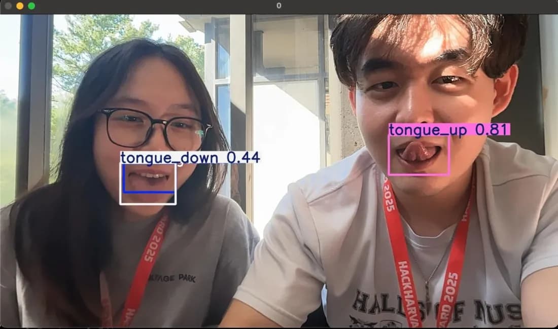Two people sticking out their tongues while the model labels them tongue_up and tongue_down.