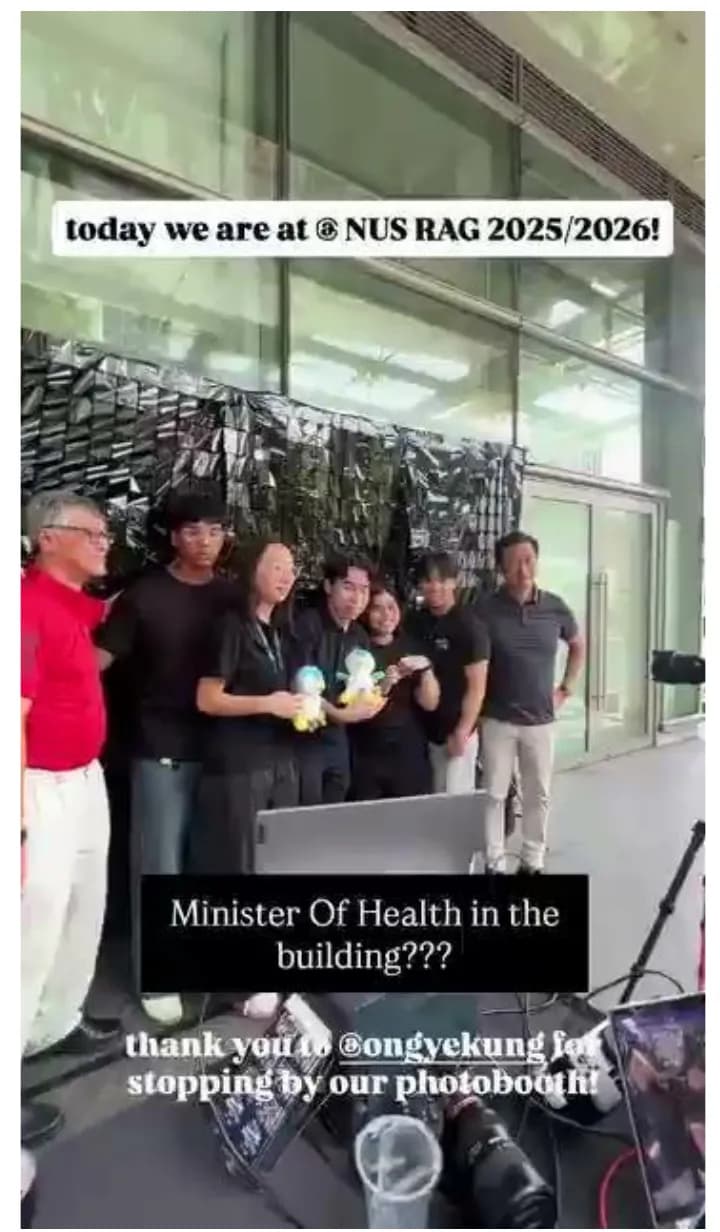 The booth's team posing with Singapore's Minister of Health at NUS RAG.